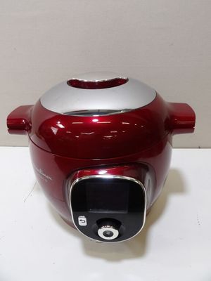 a red and silver electric cooker sitting on a counter