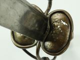 a close up of a metal object with a knife in it