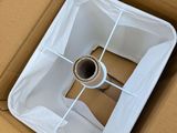 a cardboard box with a toilet in it that is open