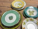many plates on the table with different designs on them