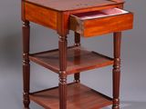a small wooden table with a drawer on top of it