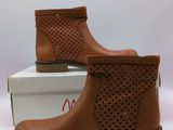 a close up of a pair of brown boots on top of a box