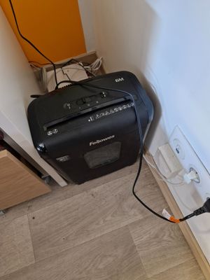 an image of a small room with a black and white radio on the floor