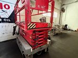 a picture of a red scissor in a warehouse