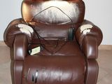 a brown recliner with a cow hider on it