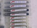 a lot of pens that are lined up on a table
