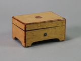 a small wooden box with a drawer on top of it