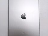 an apple ipad sitting on top of a table next to a white wall