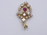 an image of a diamond and ruby pendant on a white surface
