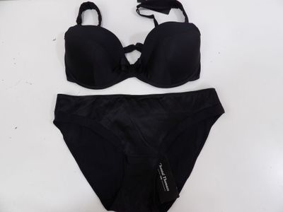 a close up of a black bikinisuit on a white surface
