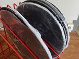 three plates in a red wire basket on a wooden table