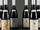 six bottles of wine are lined up in a row on a table
