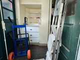 a ladder leaning against a green door in a room