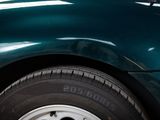 a close up of a tire on a green car