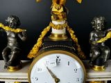a clock with a gold eagle on top of it