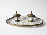 two salt and pepper shakers sitting on a plate