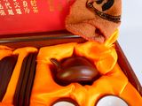 a box with a tea set and a towel in it