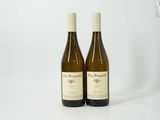 two bottles of wine sitting next to each other on a table