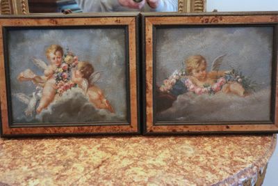 two framed pictures of cherensils on a table
