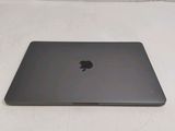 an apple macbook pro laptop computer sitting on a white surface