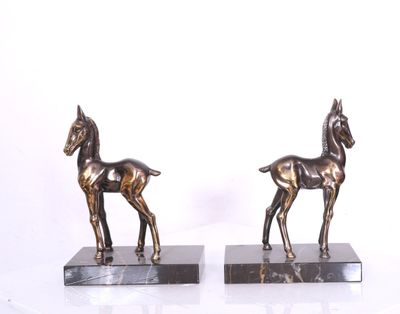 Paire de serre-livres en métal patiné or et argent à décor d…