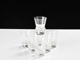 four shot glasses and a shot glass sitting on a table