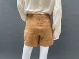 a mannequin mannequin wearing a white shirt and tan shorts
