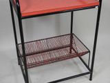 an image of a metal shelf with a red tray on it