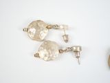 pair of silver earrings on a white background with a pocket watch