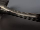 a close up of a metal spoon with a handle on a table