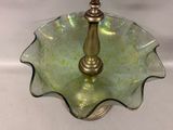 a glass bowl with a gold candle holder on it