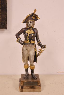 an image of a statue of a man with a hat and a sword
