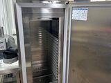 a stainless steel refrigerator in a kitchen with a glass door