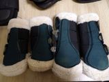 several pairs of boots are lined up on a wooden floor