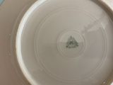 a white plate with a green tree on it