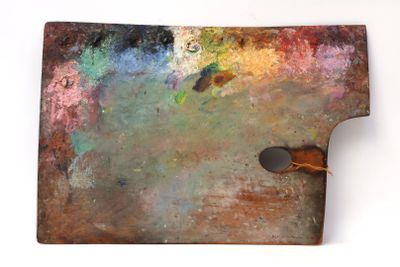 an image of a close up of a paint palette with a person standing next to it