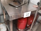 two red buckets sitting on a stainless steel table