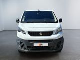 the front view of a white van parked in a white room