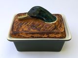 a duck on top of a cake in a square dish