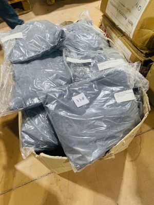 a basket full of blue plastic bags on the floor