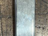 a small metal object on a wooden table