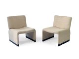 pair of beige chairs with black legs on a white background