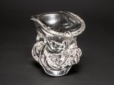 a glass vase with a design on it on a black background