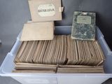 a lot of old books in a bin on the table