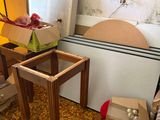 a pile of boxes and a table in the corner of a room