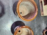 three vases that are sitting on the floor next to each other