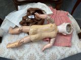 a doll that is laying on a chair with a tag on it