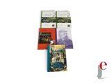four books are stacked on top of each other on a white surface
