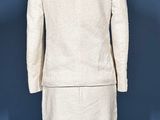 a close up of a white suit on a mannequin stand