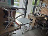tables and chairs in a restaurant with a view of the outside